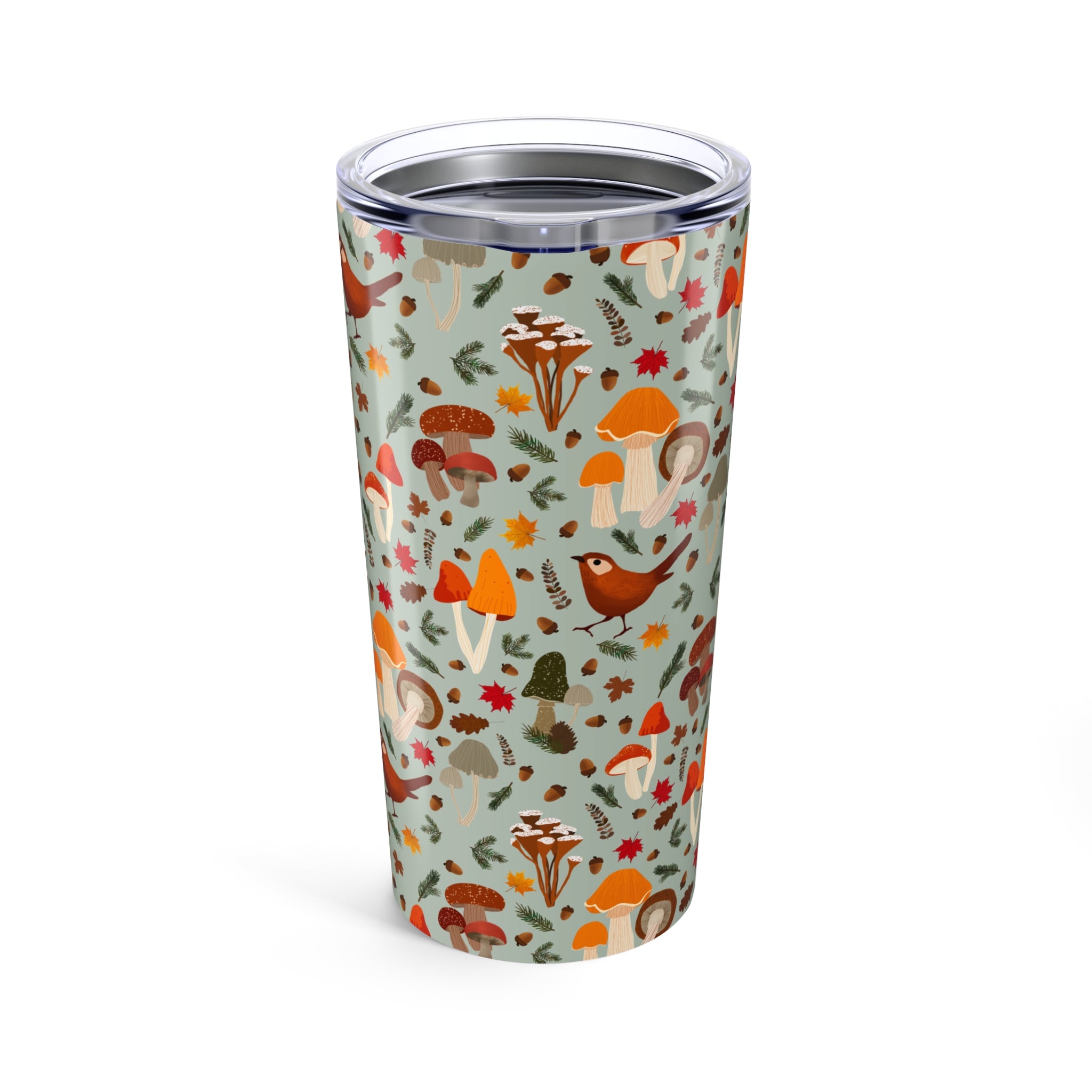 Tumbler with forest-themed design featuring mushrooms and leaves on a light blue background