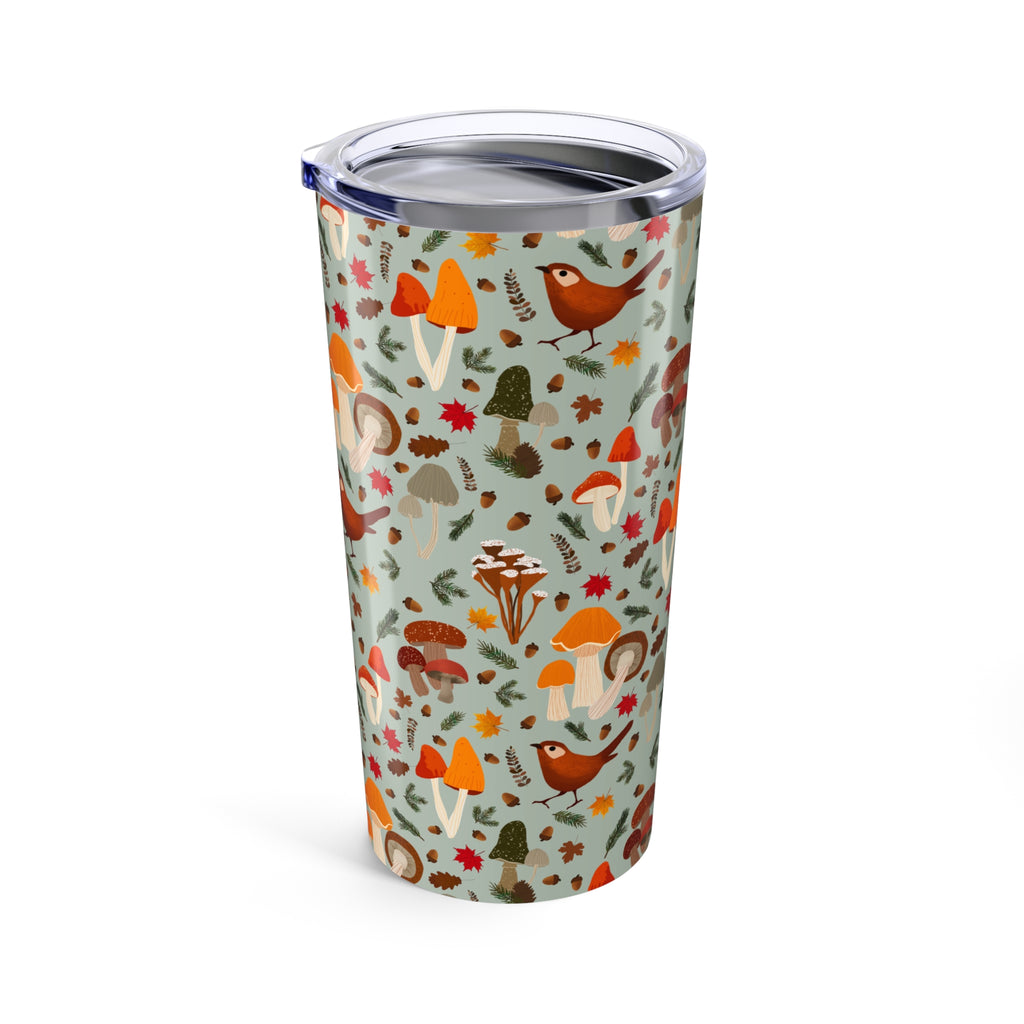 Tumbler with autumn-themed design featuring mushrooms and birds on a light blue background