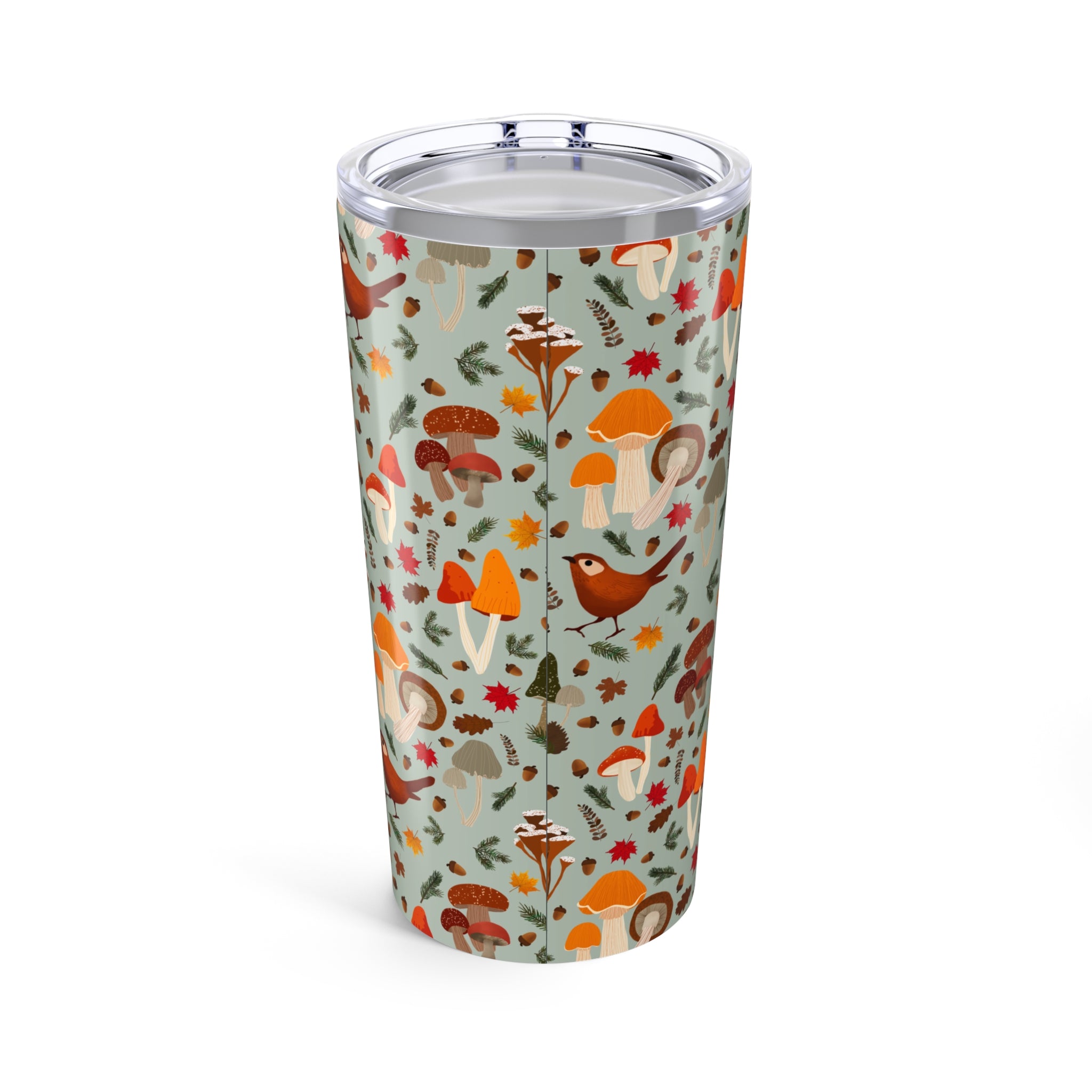 Tumbler with forest-themed design featuring mushrooms and birds on a light blue background